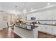 Bright, modern kitchen with an island, pendant lighting, and stainless steel appliances at 135 Goldenrod Cir, Salisbury, NC 28147