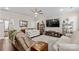 Spacious living room with hardwood floors, stylish furnishings, and a large flat screen television at 135 Goldenrod Cir, Salisbury, NC 28147