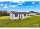 Backyard shed with white siding, black shutters, a black roof and a small ramp for easy access at 135 Goldenrod Cir, Salisbury, NC 28147