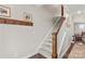 Staircase with carpeted steps, wooden handrail, and white risers connecting the floors of the home at 135 Goldenrod Cir, Salisbury, NC 28147