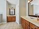 Dual vanities with wood cabinets and tile floors in spacious bathroom at 1394 Fitzgerald Nw St, Concord, NC 28027