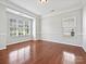 Spacious formal dining room featuring hardwood floors, crown molding, and ample natural light from large windows at 1394 Fitzgerald Nw St, Concord, NC 28027