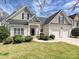 Charming two-story home with a well-manicured lawn, attached two-car garage, and classic design elements at 1394 Fitzgerald Nw St, Concord, NC 28027