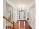 Open foyer with hardwood floors and an entrance to the house showing an elegant, well-lit interior at 1394 Fitzgerald Nw St, Concord, NC 28027