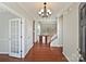Elegant foyer with hardwood floors, a chandelier, staircase, and neutral paint colors, creating a grand entrance at 1394 Fitzgerald Nw St, Concord, NC 28027