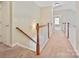 Hallway with wood railing and a carpeted floor at 1394 Fitzgerald Nw St, Concord, NC 28027
