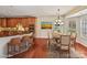 Staged kitchen boasts granite countertops, stainless appliances, wood cabinets and flows into breakfast nook at 1394 Fitzgerald Nw St, Concord, NC 28027