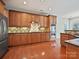 Spacious kitchen with hardwood floors, granite countertops, stainless steel appliances, and custom cabinets at 1394 Fitzgerald Nw St, Concord, NC 28027