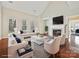 Staged living room with a cozy fireplace, hardwood floors, comfortable seating, and natural lighting at 1394 Fitzgerald Nw St, Concord, NC 28027