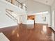 Open-concept home featuring hardwood floors, staircase, and kitchen area with bar seating at 1394 Fitzgerald Nw St, Concord, NC 28027
