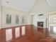 Spacious living room featuring hardwood floors, a fireplace, and multiple windows for natural light at 1394 Fitzgerald Nw St, Concord, NC 28027