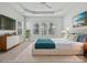 Staged main bedroom features a modern design, tray ceilings, large windows and a TV at 1394 Fitzgerald Nw St, Concord, NC 28027