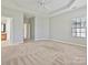 Spacious main bedroom with a tray ceiling, ceiling fan and adjoining bathroom at 1394 Fitzgerald Nw St, Concord, NC 28027