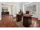 Office features hardwood floors, a large desk, and ample natural light, creating an ideal workspace at 1394 Fitzgerald Nw St, Concord, NC 28027