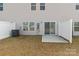A small backyard features a patio, vinyl fence, AC unit, and sliding glass doors at 140 S Bell Ave, Albemarle, NC 28001