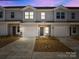 A daytime exterior shot of townhomes showing garage parking and craftsman style front doors at 140 S Bell Ave, Albemarle, NC 28001