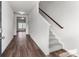 View of foyer and stairwell with carpeted steps and laminate floors at 140 S Bell Ave, Albemarle, NC 28001