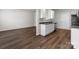 Galley kitchen with sink and dishwasher on one side, appliances on the other at 140 S Bell Ave, Albemarle, NC 28001