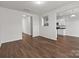 Large living area with laminate flooring and access to a modern kitchen at 140 S Bell Ave, Albemarle, NC 28001