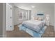 Bright bedroom features large windows, neutral paint, and stylish blue decor at 142 S Bell Ave, Albemarle, NC 28001