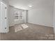 Bright bedroom with carpet, natural light from a bank of windows, and neutral walls at 142 S Bell Ave, Albemarle, NC 28001