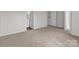Neutral-toned bedroom features large windows and an ensuite bathroom at 142 S Bell Ave, Albemarle, NC 28001