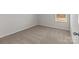 Carpeted bedroom features neutral paint and one large window at 142 S Bell Ave, Albemarle, NC 28001
