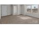 Well-lit, spacious bedroom with neutral walls and carpeting, featuring large windows at 142 S Bell Ave, Albemarle, NC 28001