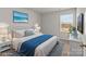 Cozy bedroom featuring a queen-sized bed, nightstands, and a bright window view at 142 S Bell Ave, Albemarle, NC 28001