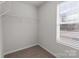 Walk-in closet is bright with wire shelving and a window at 142 S Bell Ave, Albemarle, NC 28001