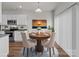 Open-concept dining room adjacent to the kitchen with natural light and a decorative area rug at 142 S Bell Ave, Albemarle, NC 28001