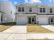 Charming townhome with a one car garage, well maintained lawn, and attractive front door at 142 S Bell Ave, Albemarle, NC 28001
