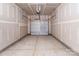 Spacious unfinished garage featuring a roll-up door at 142 S Bell Ave, Albemarle, NC 28001