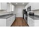 Well-lit kitchen with stainless steel appliances, granite countertops, and plenty of cabinet storage at 142 S Bell Ave, Albemarle, NC 28001