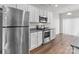Bright kitchen featuring stainless steel appliances, granite countertops, and sleek white cabinetry at 142 S Bell Ave, Albemarle, NC 28001