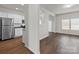 Open-concept living room features wood floors and lots of natural light from the double windows at 142 S Bell Ave, Albemarle, NC 28001