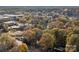 Scenic aerial view of a community park, green space, and landscape surrounded by colorful trees in autumn at 14725 N Old Statesville Rd, Huntersville, NC 28078