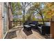 Outdoor seating arrangement on a wooden back deck surrounded by lush trees and foliage at 14725 N Old Statesville Rd, Huntersville, NC 28078