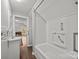 This bright bathroom features a tub and a single sink vanity, with doorway to another room at 14725 N Old Statesville Rd, Huntersville, NC 28078