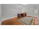 Bright bedroom features hardwood floors, vintage rug, a desk, and natural light at 14725 N Old Statesville Rd, Huntersville, NC 28078
