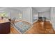 Bright bedroom features hardwood floors, vintage rug, a desk, and natural light at 14725 N Old Statesville Rd, Huntersville, NC 28078