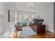 Bedroom with wood floors, natural light, and a large work area at 14725 N Old Statesville Rd, Huntersville, NC 28078