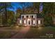 Charming brick home with black shutters, a columned portico and walkway at 14725 N Old Statesville Rd, Huntersville, NC 28078