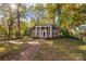 Charming brick home with black shutters, a columned portico and walkway at 14725 N Old Statesville Rd, Huntersville, NC 28078
