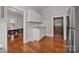 Cozy kitchen with wood floors, white cabinets, and adjacent dining area at 14725 N Old Statesville Rd, Huntersville, NC 28078