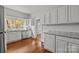 Charming kitchen features wood floors, white cabinets, granite countertops, and stainless steel appliances at 14725 N Old Statesville Rd, Huntersville, NC 28078