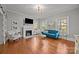 Bright living room with fireplace, hardwood floors and blue sofa at 14725 N Old Statesville Rd, Huntersville, NC 28078