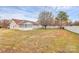 Sprawling back yard featuring a spacious lawn, fenced perimeter, and a screened in porch at 15707 Southern Garden Ln, Charlotte, NC 28278