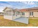 A Backyard patio and screened in porch extends to a spacious lawn and solar panels at 15707 Southern Garden Ln, Charlotte, NC 28278
