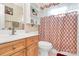 Bathroom featuring a vanity with storage, toilet, and patterned shower curtain at 15707 Southern Garden Ln, Charlotte, NC 28278
